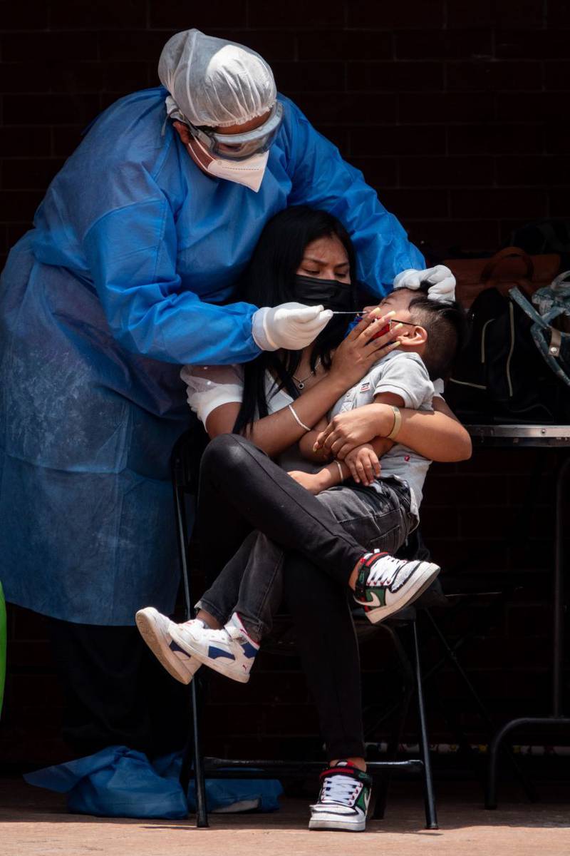 Una médico aplica una prueba covid-19 a un niño en el kiosco covid-19 en la alcaldía Cuahtémoc