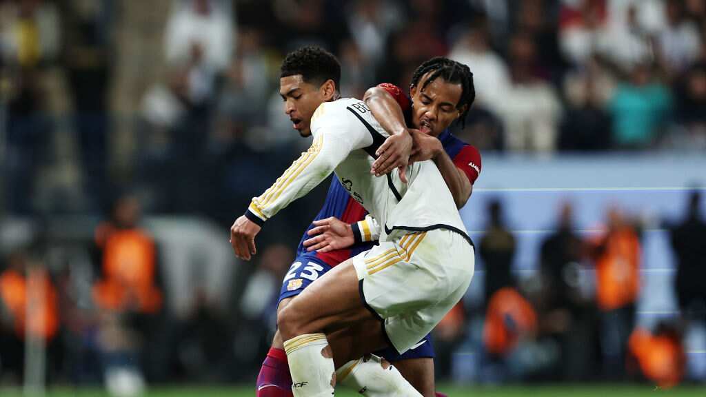 Jude Bellingham y Jules Koundé disputando un balón.