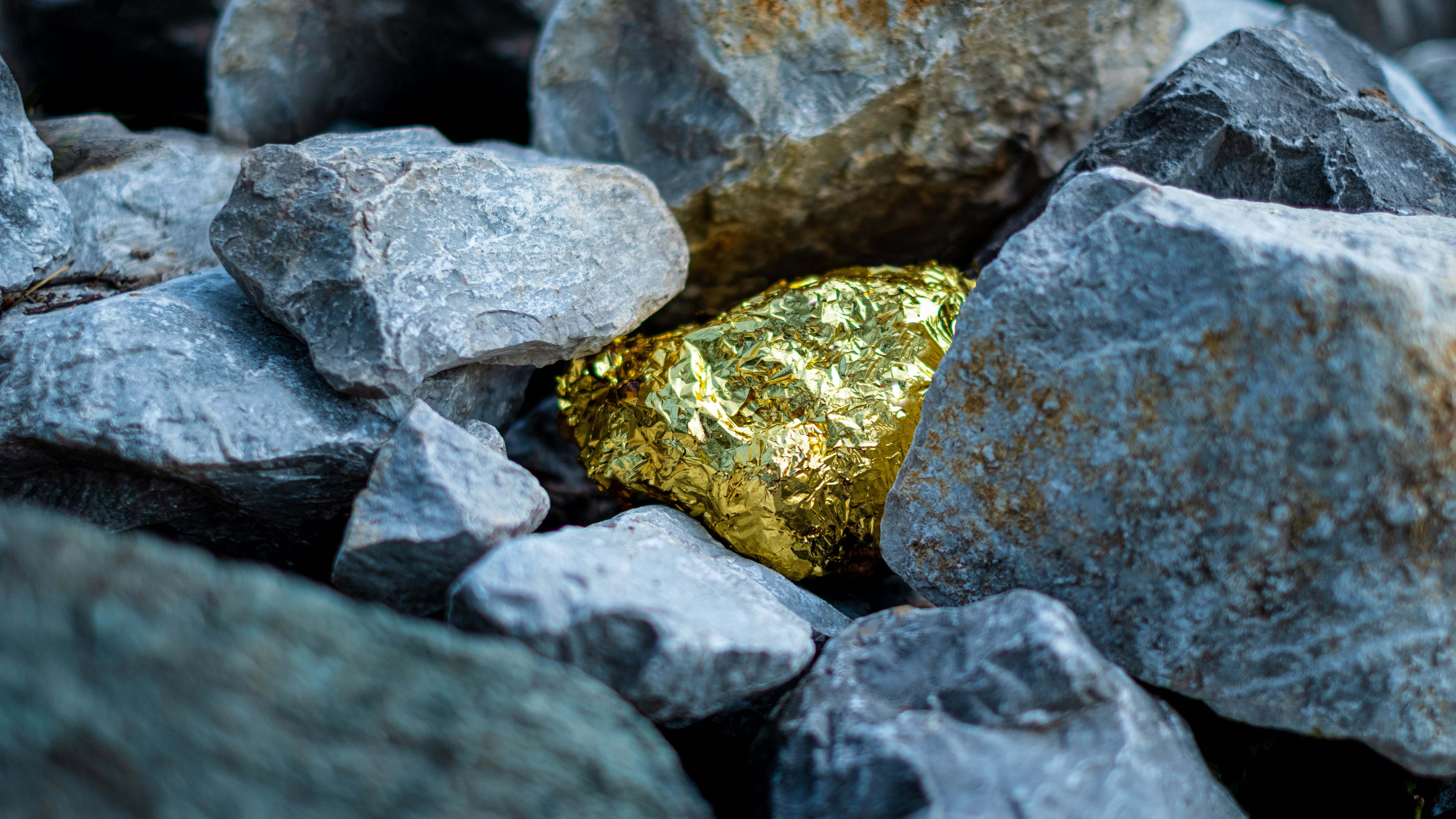 Gold nugget and grey granite stone background
