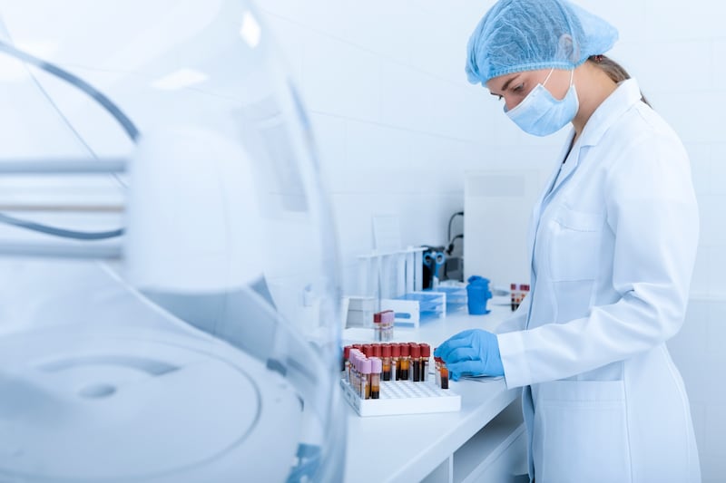 Mujer recolectando muestras de sangre para realizar pruebas sobre diferentes enfermedades, laboratorio moderno