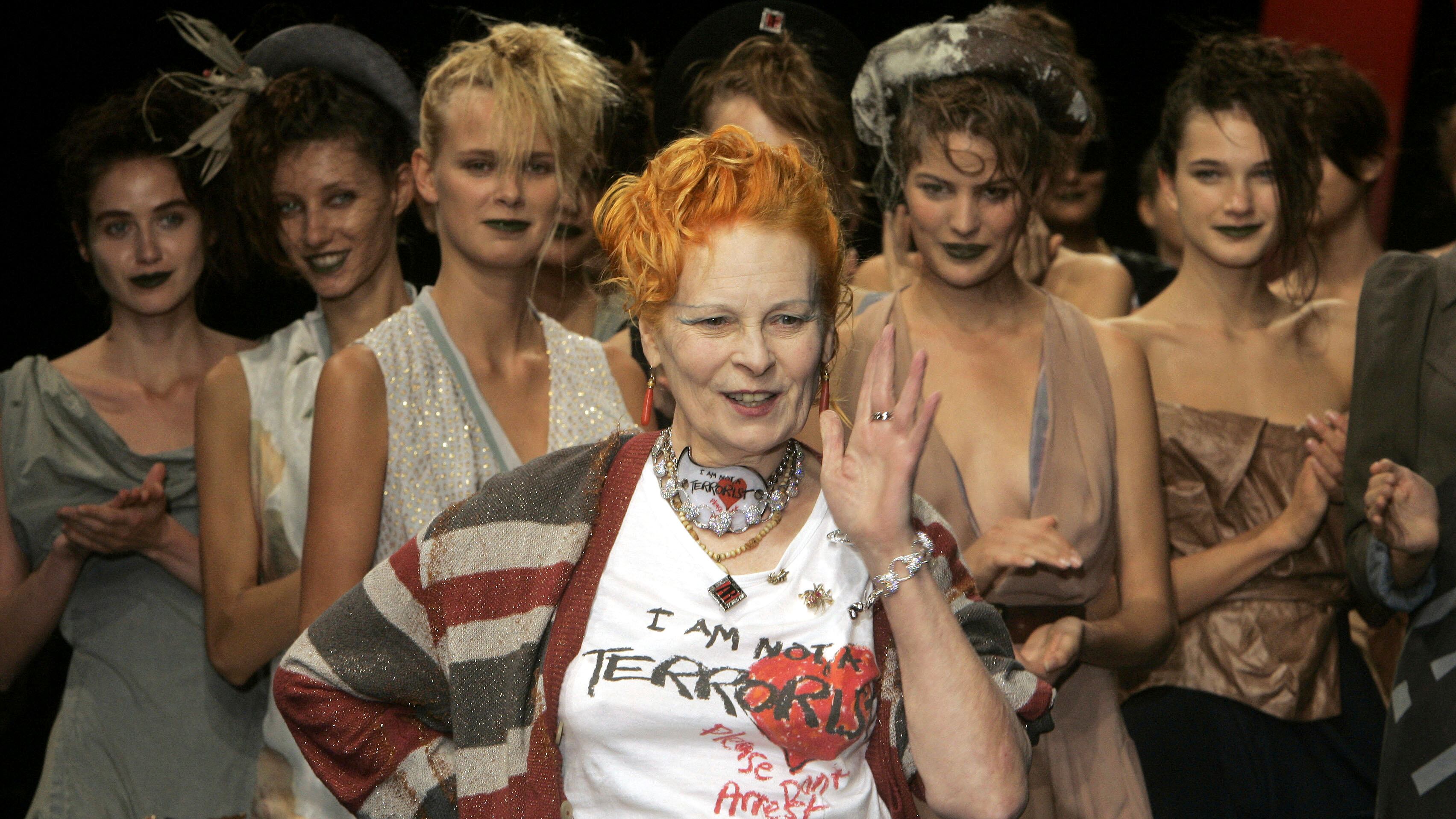 FILE - Models applaud as British fashion designer Vivienne Westwood salutes the public after the presentation of her Spring/Summer 2006 collection in Paris, Tuesday, Oct. 4, 2005. Westwood, an influential fashion maverick who played a key role in the punk movement, died Thursday, Dec. 29, 2022, at 81. (AP Photo/Michel Euler, File)
