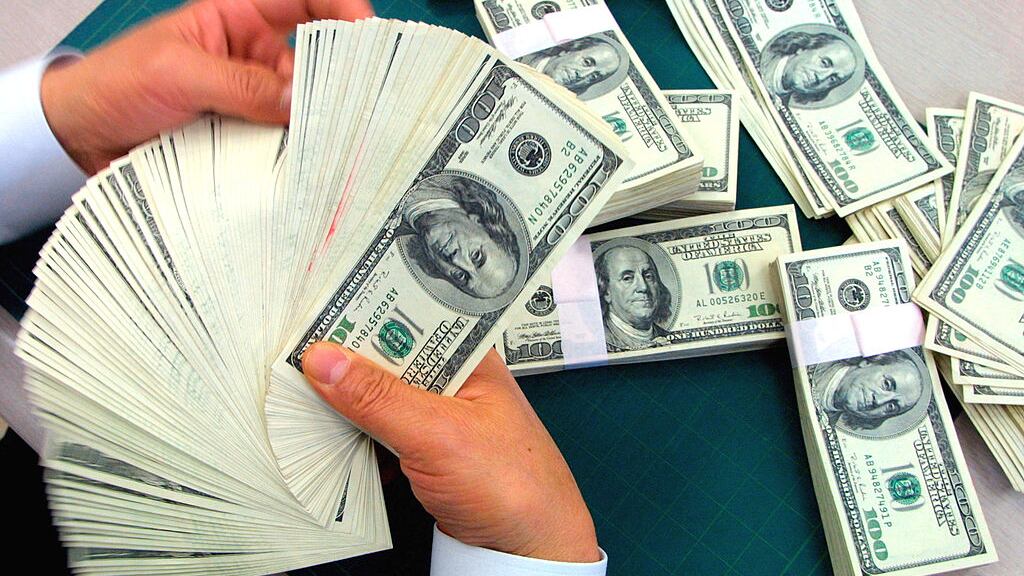 SEOUL, SOUTH KOREA - MARCH 12: A bank employee counts U.S. dollars banknotes at the headquarters of the Korea Exchange Bank March 12, 2003 in Seoul, South Korea. The dollar began stronger against the won amid a bleak economic outlook and the growing concerns over the North Korean nuclear crisis, closing at 1,245 won per dollar, up 15.10 won.